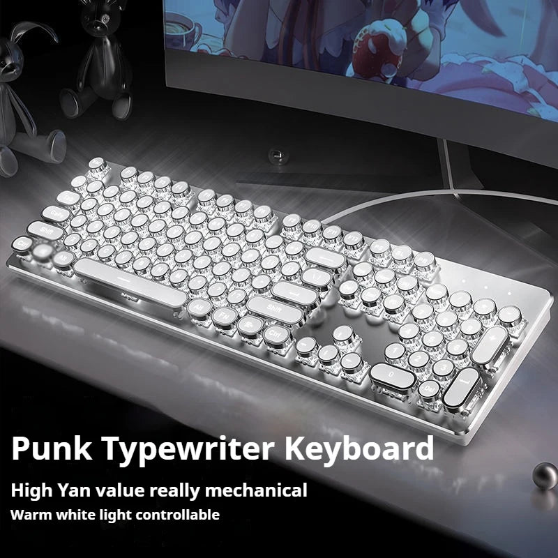 Punk typewriter keyboard on a desk with a computer monitor in the background